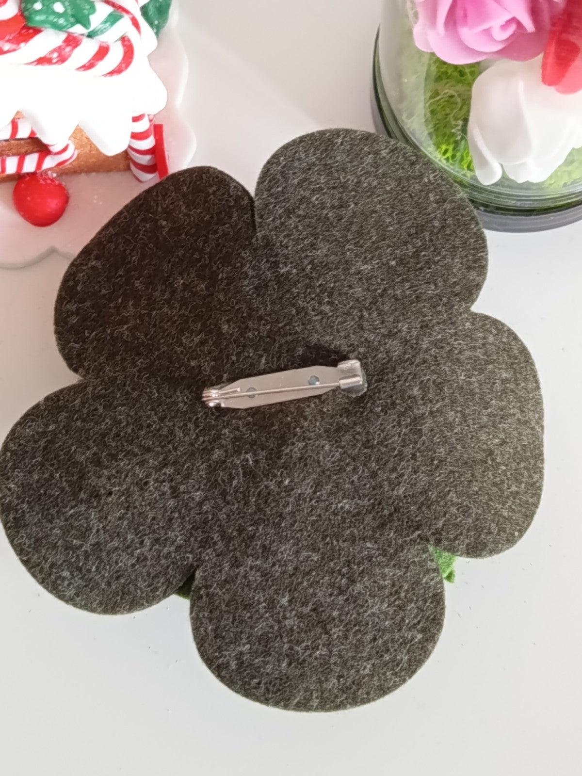 Une arrière de la broche fleur en feutrine montrant le système de fixation par épingle de sûreté métallique robuste.